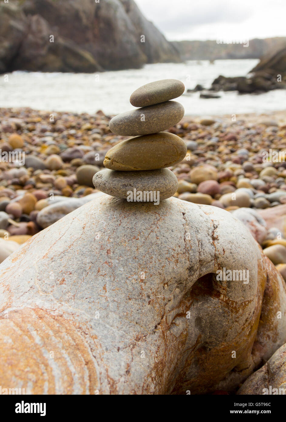 Colored stones set in balance on a beach Stock Photo - Alamy