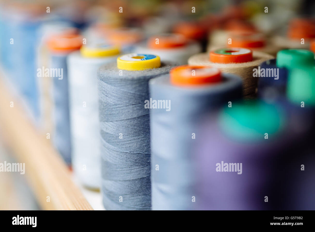 Colorful thread spools used in fabric and textile industry Stock Photo