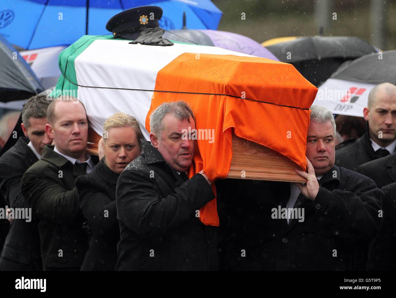 Detective Garda Joe Ryan who witnessed the murder (right) helps carries the coffin during the state funeral of Detective Garda Adrian Donohoe in Dundalk today. Stock Photo