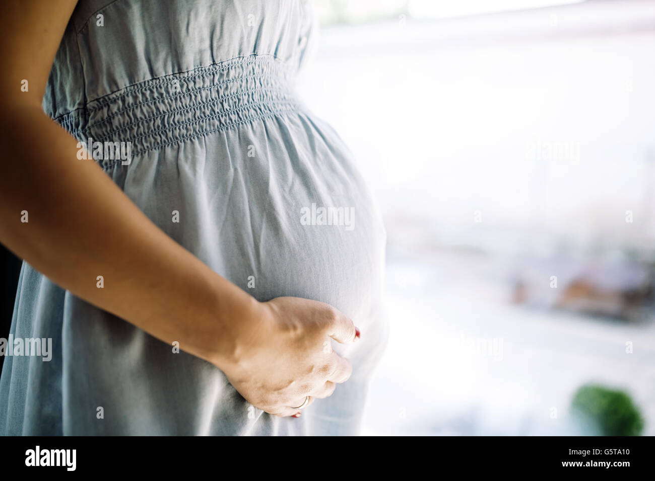 Beautiful pregnant woman holding her belly Stock Photo - Alamy