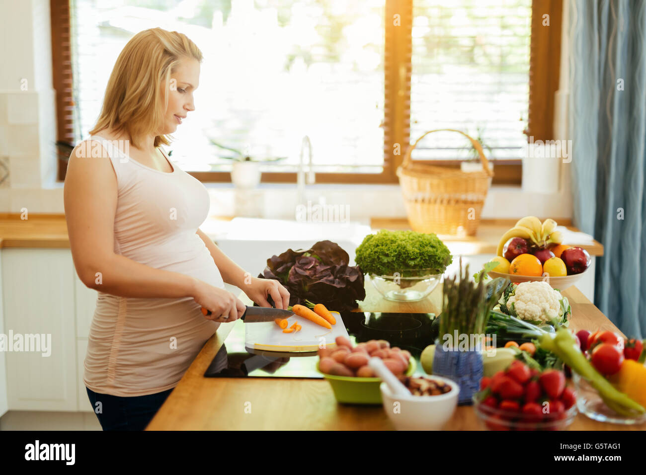 Pregnant woman eating healthy preparing meal from fresh ingredients