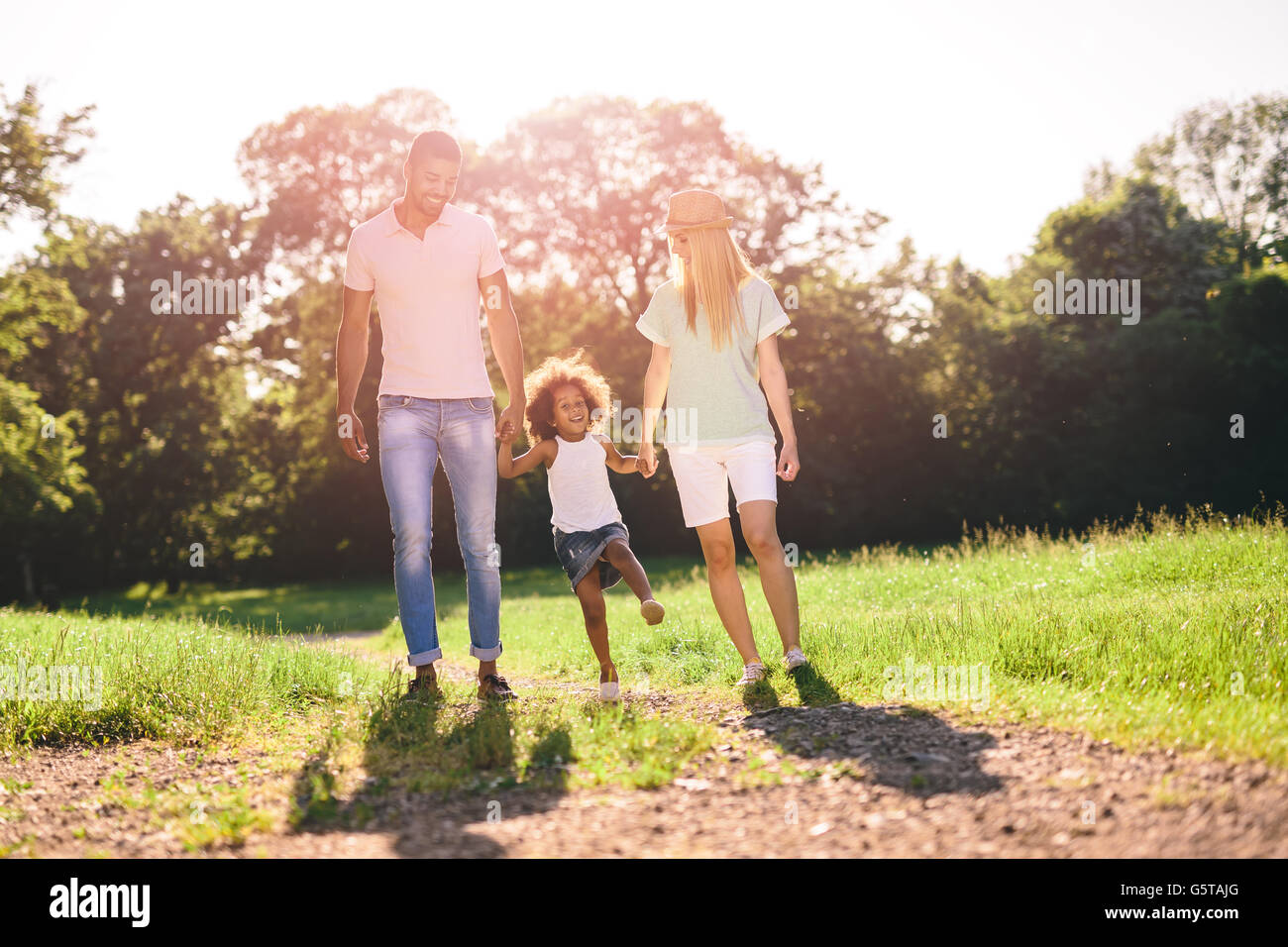 Family taking a walk in nature in a beautiful park Stock Photo