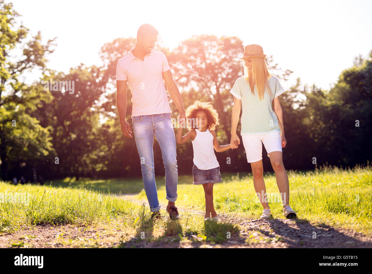 Family taking a walk in nature in a beautiful park Stock Photo