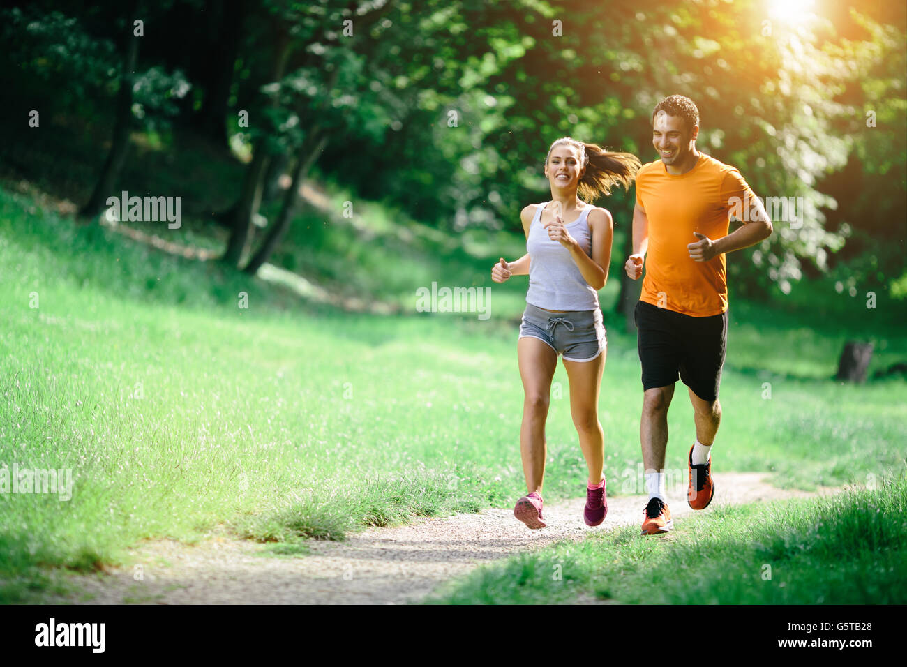 Healthy couple jogging in nature in good spirit Stock Photo