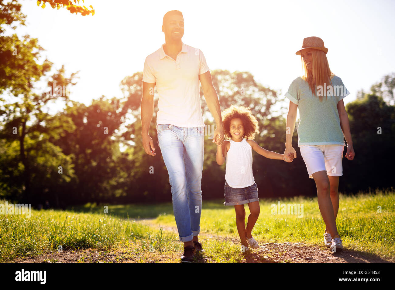 Family taking a walk in nature in a beautiful park Stock Photo