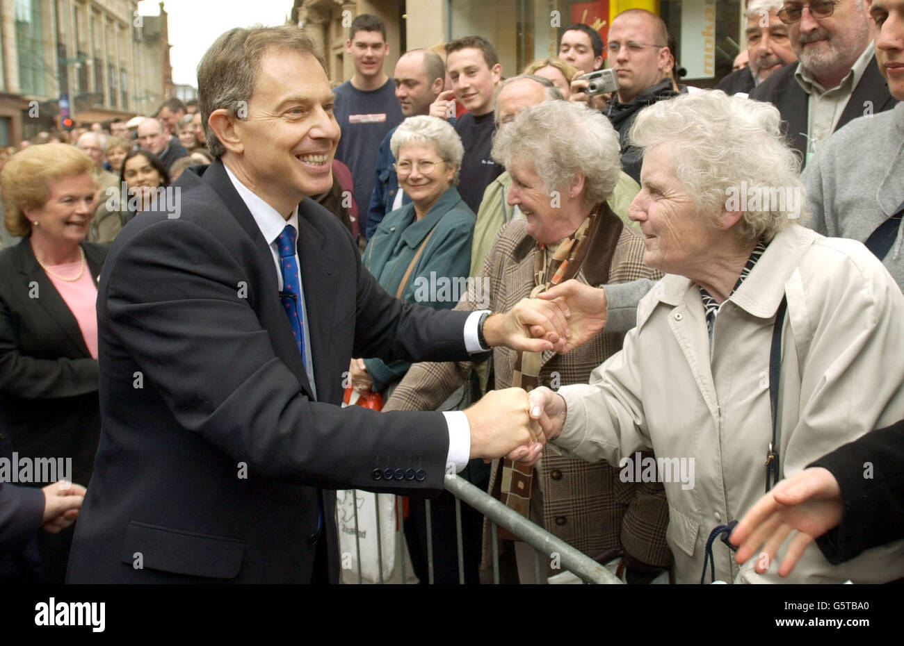 Prime Minister Tony Blair, greets wellwishers after unveiling a statue of the late Donald Dewar in Glasgow. Stock Photo