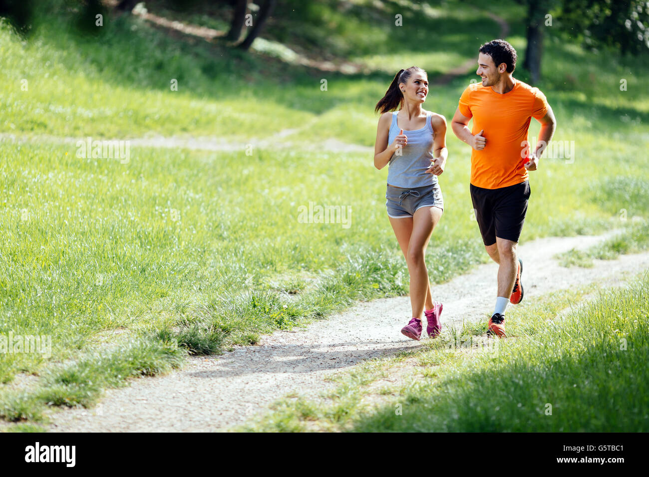 Beautiful couple jogging in nature living healthy Stock Photo - Alamy