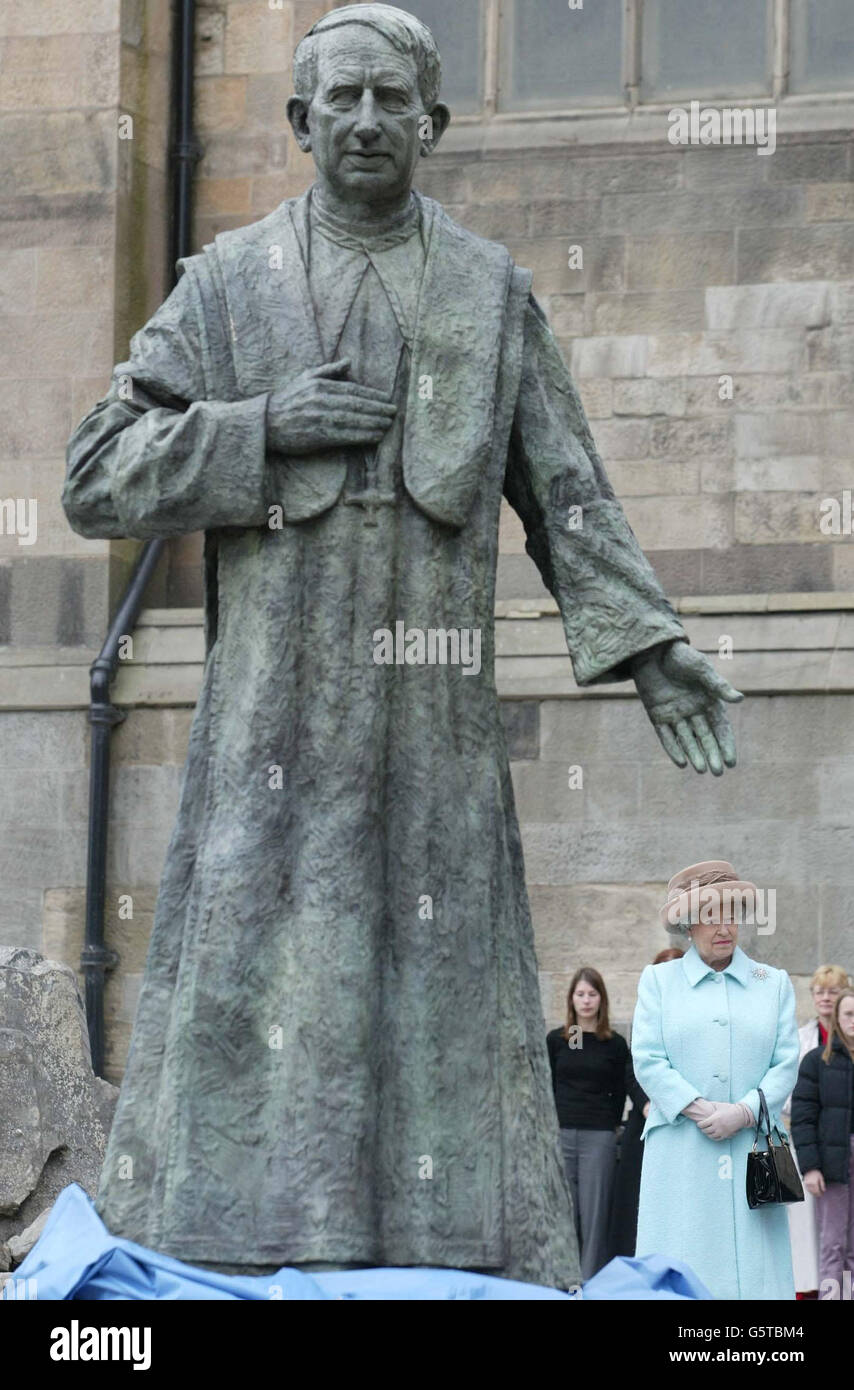 Queen Elizabeth II , looks on as she unveils the statue of the Late Cardinal Hume at St Mary's Cathedral in Newcastle. The Queen arrived in the North East on the second leg of her nationwide Golden Jubilee tour. Accompanied by the Duke of Edinburgh, she travelled overnight. *... to the North East on the Royal Train. Stock Photo