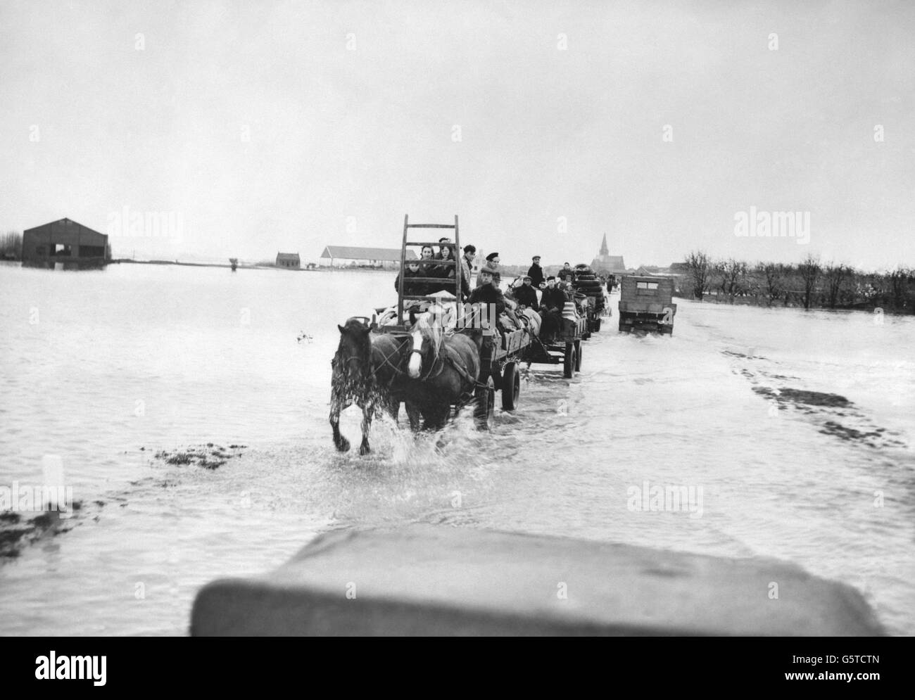 Inhabitants of Kruiningen, Zuid Beveland, Holland, use horse-drawn carts to cross flood waters as they flee their homes. Stock Photo