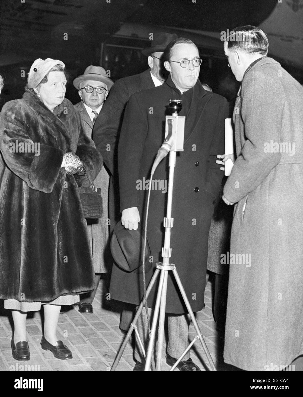 Queen Juliana greets Prince Bernhard of the Neatherlands at Schiphol Aerodrome, after his hurried flight home from New York owing to the flood catastrophe. Stock Photo