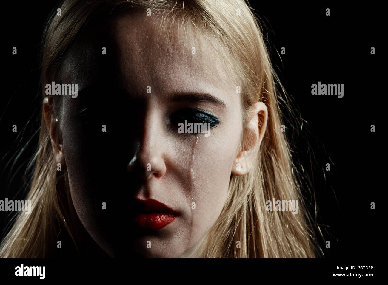 sad girl crying on black background Stock Photo - Alamy
