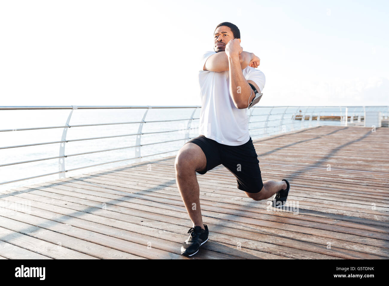 Sporty african man stretching arms hi-res stock photography and images ...