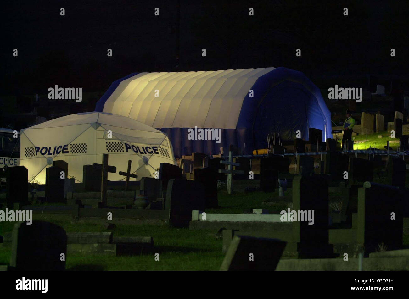 A police tent covers the grave of Joseph Kappen at Goytre Cemetery near Port Talbot, South Wales, as dawn breaks. Police are exhuming his body because Kappen is a prime suspect in the investigation into the murders of three teenage girls nearly 30 years ago. Stock Photo