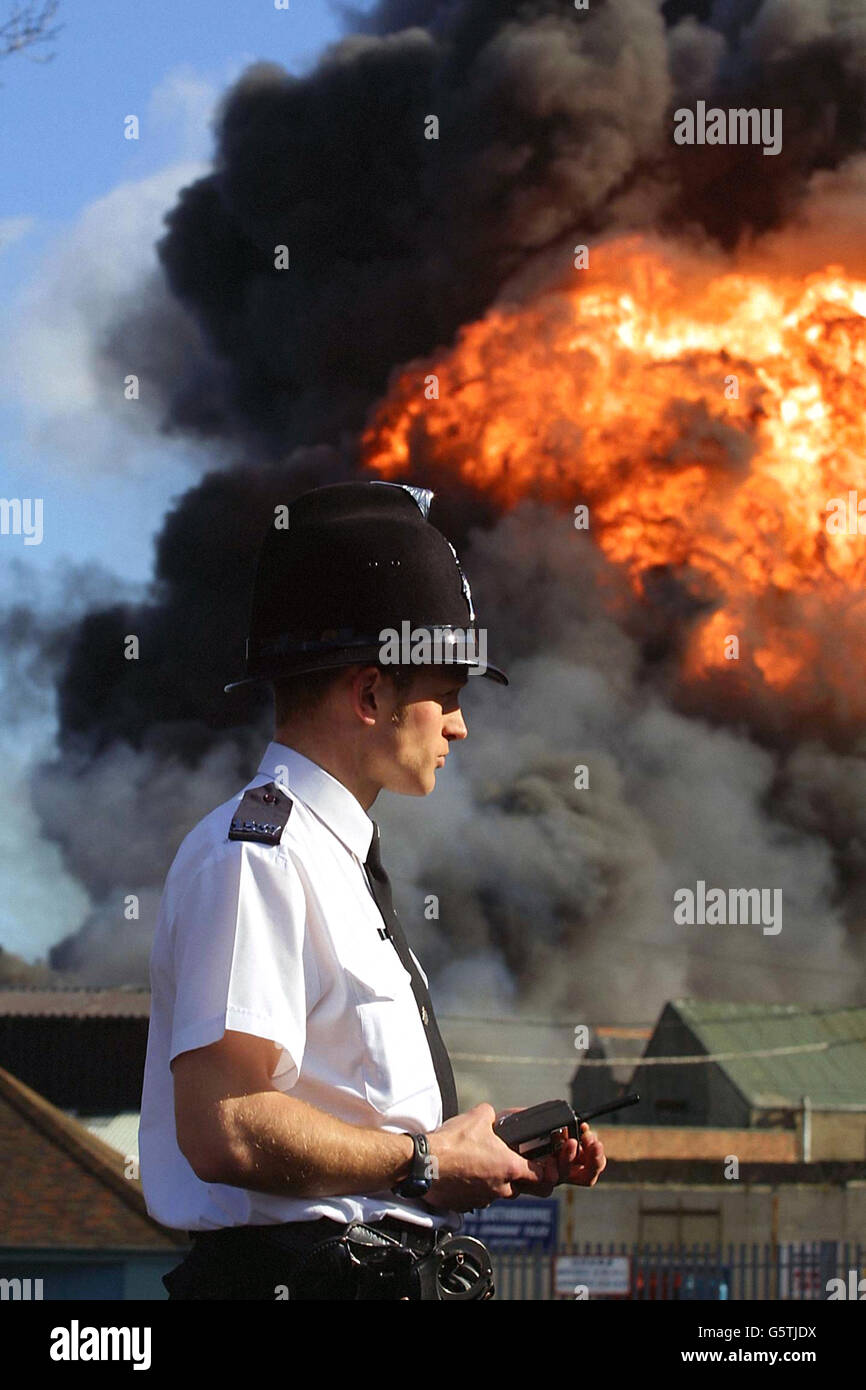 A policeman surveys the scene at the Distillex plant in East Percy Street, North Shields, Tyne & Wear after a huge blaze erupted. No reports have yet been received about any injuries. One eyewitness said fumes could be seen from the site about 15 miles away at Newcastle Airport. *She said: 'The volume of smoke is immense, people are driving around just looking and wondering what has happened. It is a steely grey smoke with great clouds billowing up, you can even smell it as well.' A Tyne & Wear Fire Brigade spokesman said 10 fire engines and a turntable vehicle were at the plant. Stock Photo