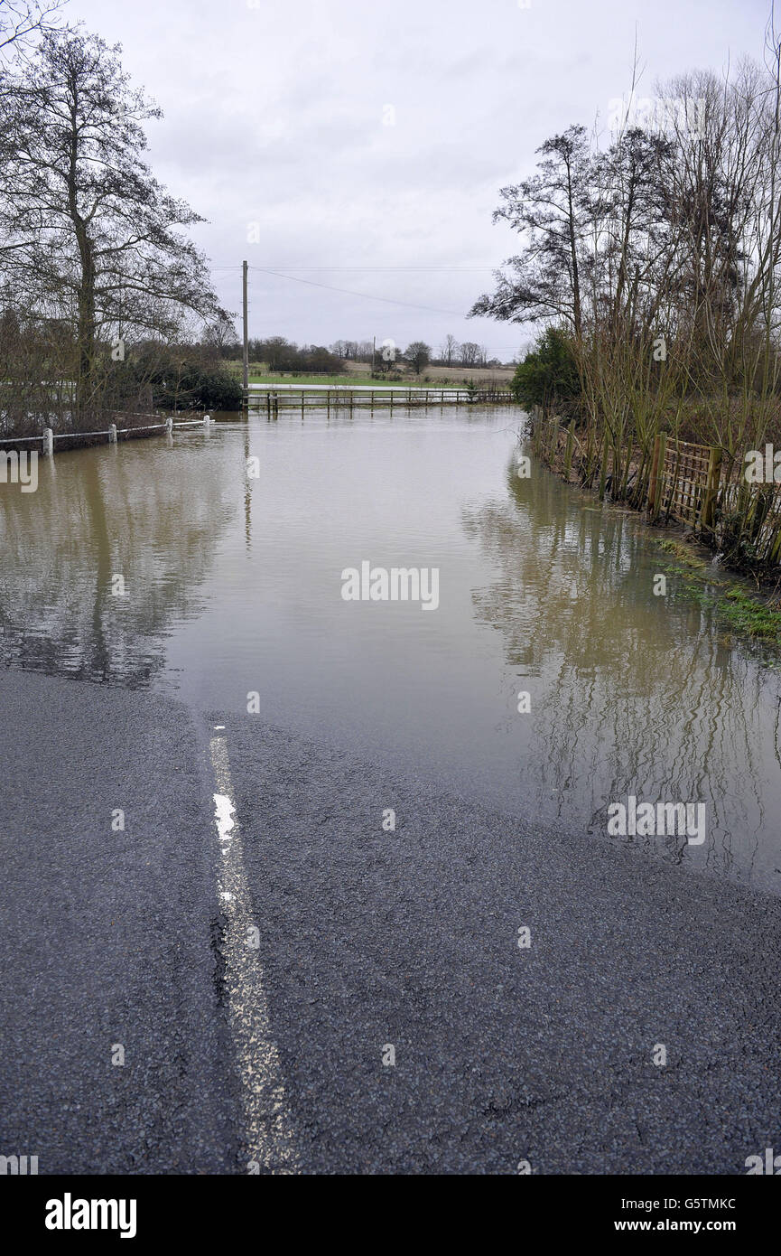 The River Chelmer, floods the roadway at Paper Mill Lock, Little Baddow, Essex as recent snowmelt from surrounding fields raised the river's volume. Stock Photo