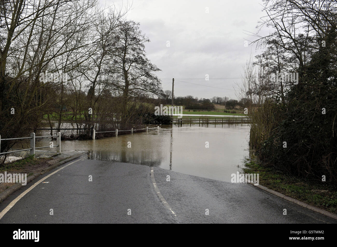 The River Chelmer, floods the roadway at Paper Mill Lock, Little Baddow, Essex as recent snowmelt from surrounding fields raised the river's volume. Stock Photo