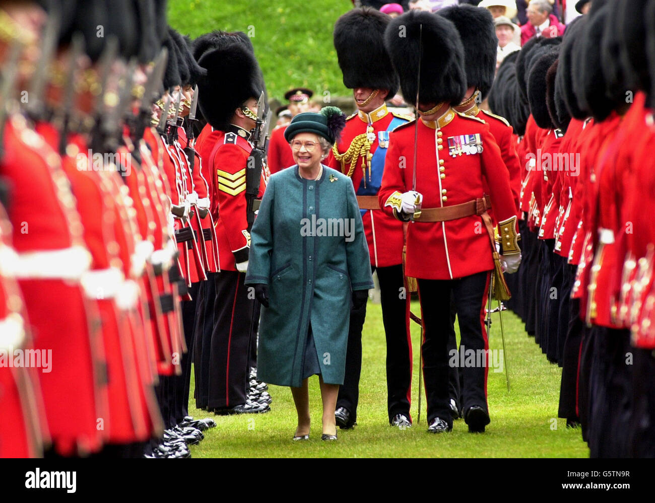 Britain's Queen Elizabeth II smiles as she inspects Scots Guards at Windsor Castle with the regiment's Colonel in Chief, she presented new colours to both its 1st Battalion and F Company, formerly the 2nd Battalion. *... The new colours bear the latest battle honours of the Scots Guards and are embroidered: Gulf 1991. Stock Photo