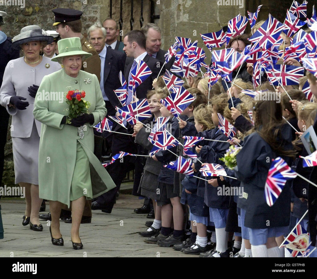 Britain's Queen Elizabeth II being greeted by a sea of flags outside ...