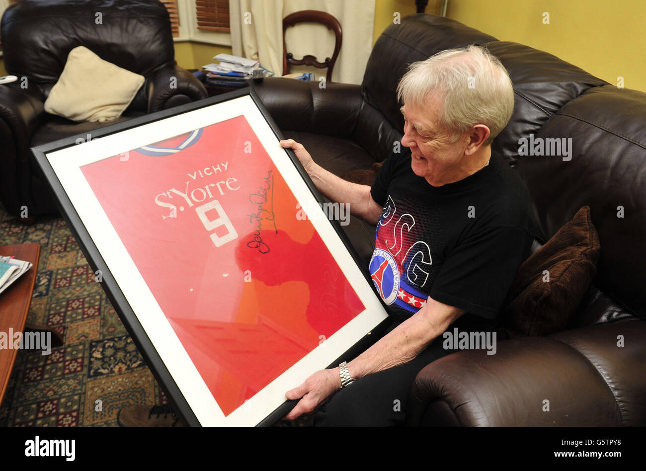 Soccer - Jantzen Derrick Feature - Bristol. Former PSG and Bristol City player Jantzen Derrick poses with a framed shirt, at his home in Bristol. Stock Photo
