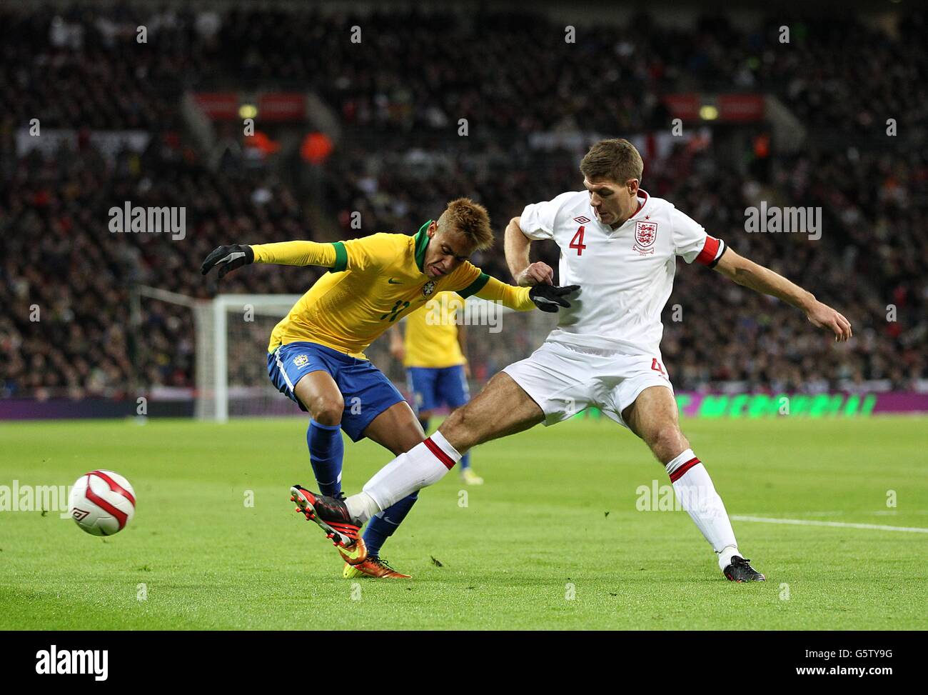Soccer - International Friendly - England v Brazil - Wembley Stadium. England's Steven Gerrard (right) and Brazil's Junior Neymar (left) battle for the ball Stock Photo
