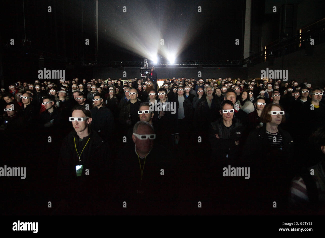 The audience wearing 3D glasses watching German electronic music