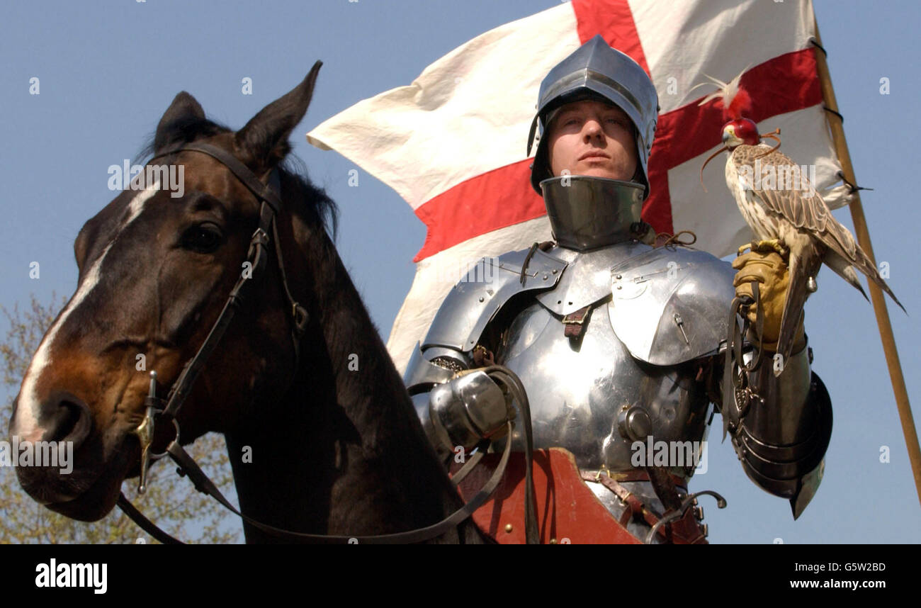 A 'Medieval Knight', alias Dominic Sewell, 34, from Peterborough, riding Tequila and holding Willow, a female Saker falcon, against the St Georges flag at London's Hyde Park Corner on St Georges Day. *....They were there to launch the opening of ticket sales for English Heritage's forthcoming History In Action festival to be held at Kirby Hall, Northamptonshire on the 10th and 11th August Stock Photo