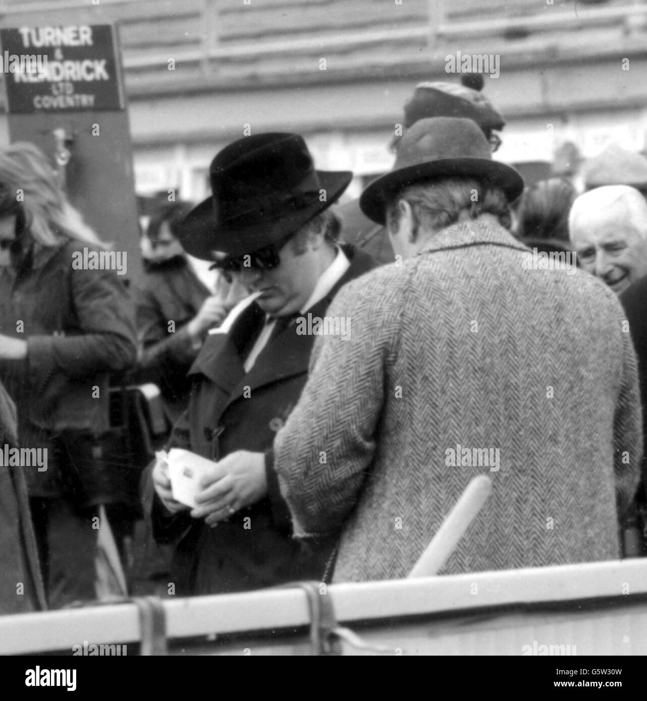 Bookmaker John Banks (dark glasses) at Cheltenham for the Gold Cup, with ex-champion John Francome. Banks is to face a Jockey Club inquiry into allegations of bribery and corruption. Stock Photo