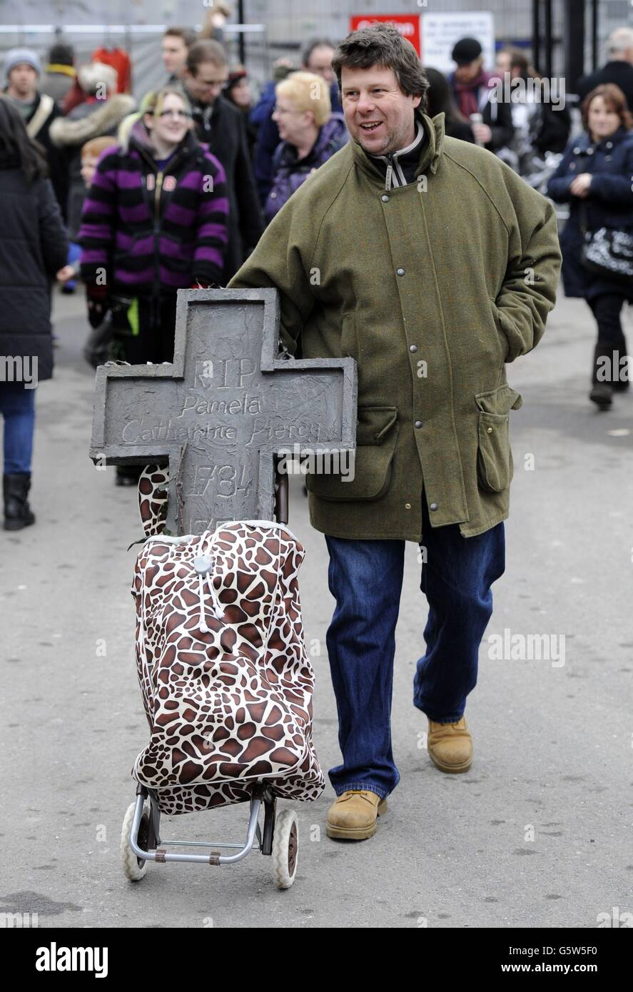 Robert Stewart from Waltham Abbey, Essex, leaves with items purchased at the London Dungeon 'Carnage Car Boot Stall' held at the Capital Car Boot Sale in Chichester Street, Pimlico, London. Stock Photo