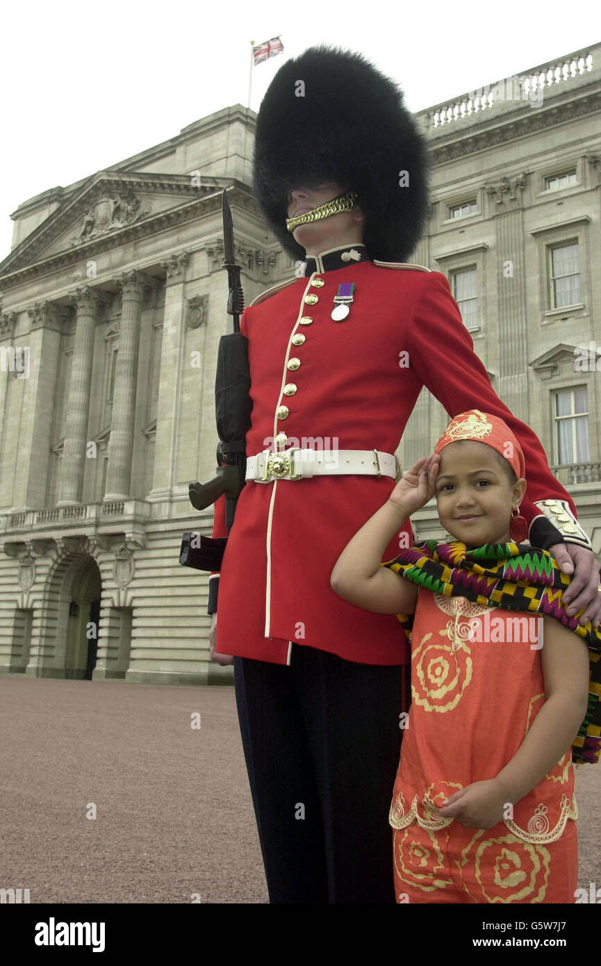 John Dodsworth A Guardsman From The Queen S Company First Battalion Grenadier Guards And Daniella Okezi Aged Seven From Swiss Cottage In London Wearing Ghananian National Costume In The Forecourt Of Buckingham Palace