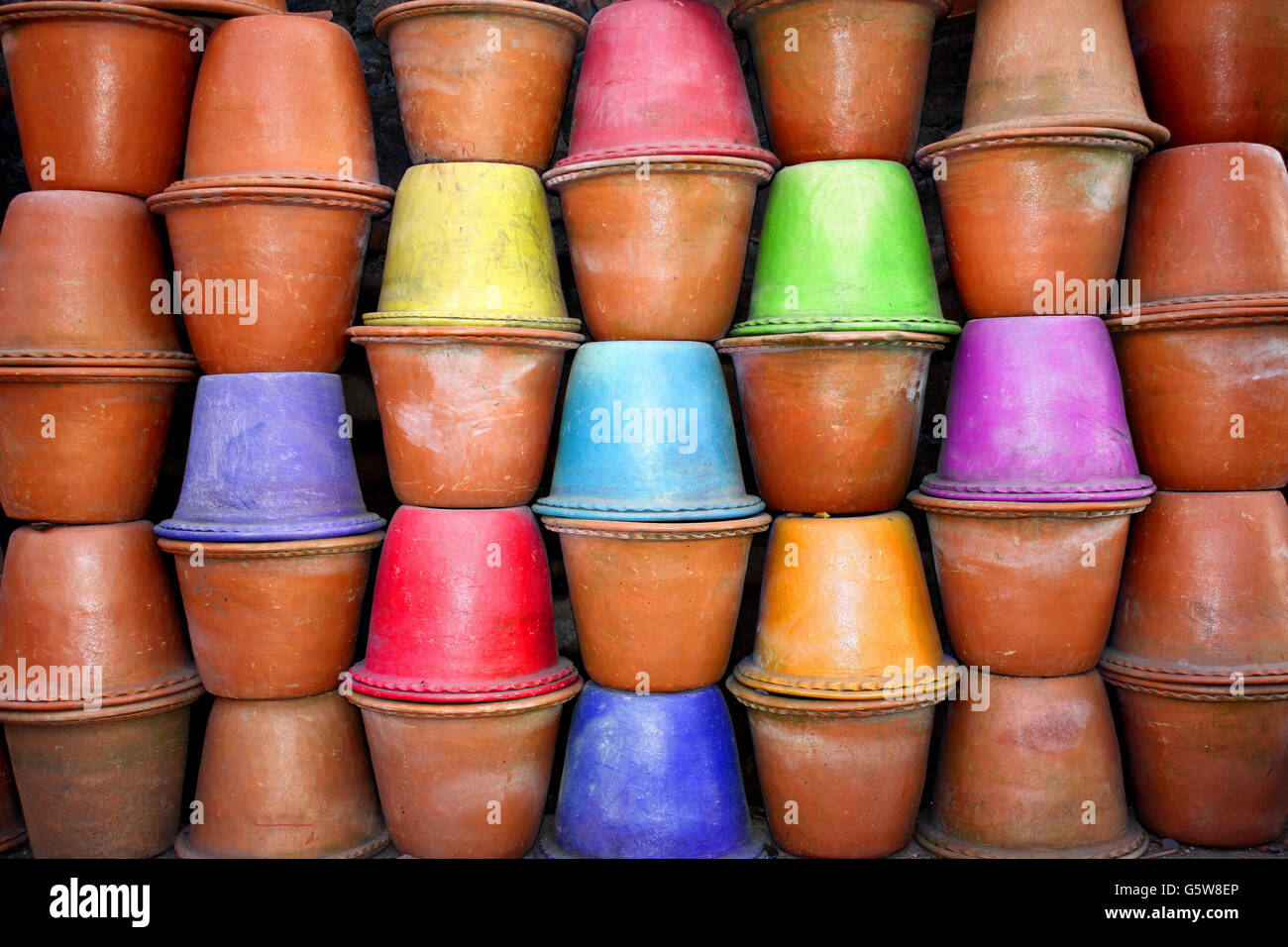 A background of red clay pots with some colored pots in them, for gardening  Stock Photo - Alamy