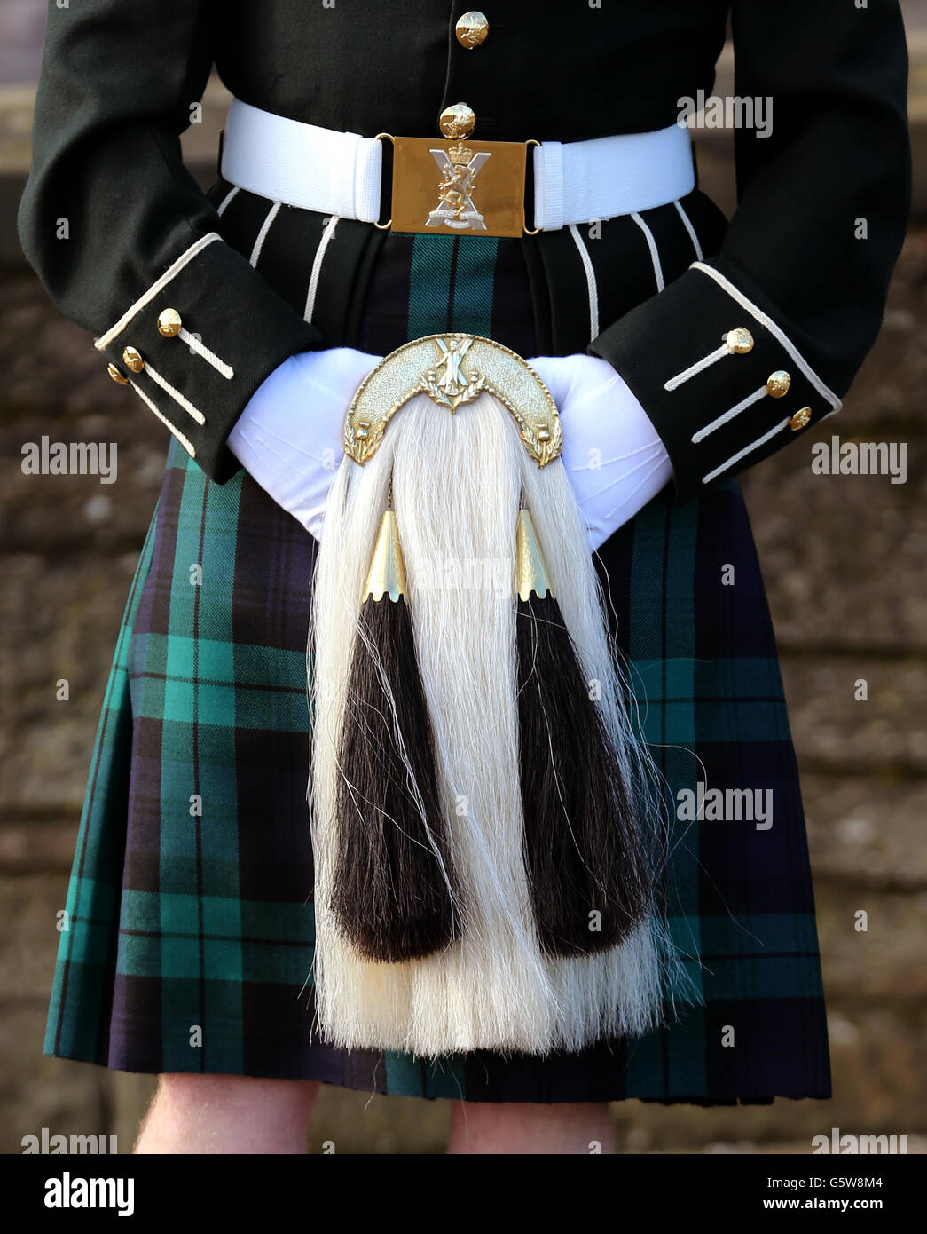 A soldier from the The Royal Regiment of Scotland keeps his hands warm whilst on duty at Edinburgh Castle. Stock Photo