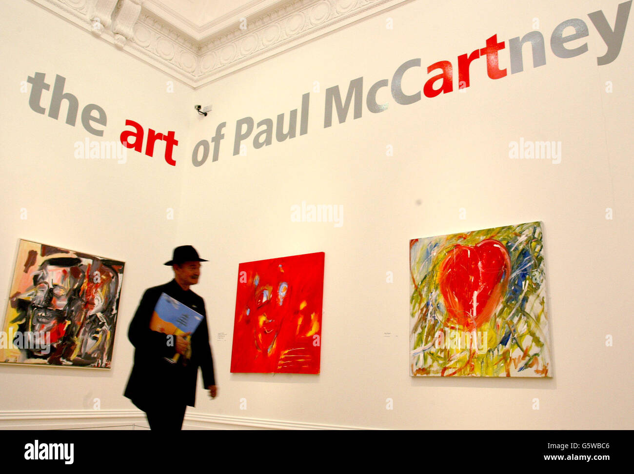 An art critic makes his way through the works of Sir Paul McCartney, which he has dedicated to his wife-to-be Heather Mills, which go on display along with other examples of his work at Liverpool's Walker Art gallery in an exhibition called 'the art of Paul McCartney. Stock Photo