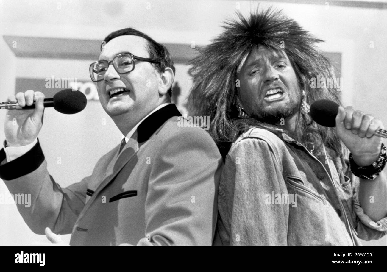 Weatherman Ian McCaskill attempts an impression of David Bowie with Kenny Everett, who is pretending to be Tina Turner, when they team up for a duet of 'It's Raining Men' on the Kenny Everett TV Show on BBC One. Stock Photo