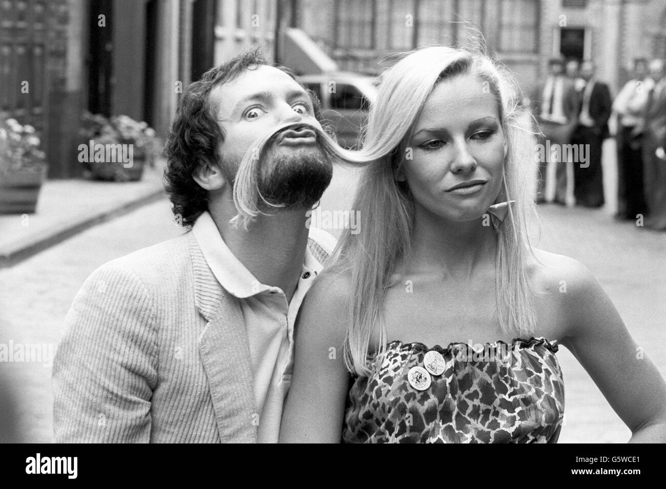 Pamela Stephenson looks unimpressed with Kenny Everett's antics in London today. Both comics feature in the BBC's autumn and winter schedule, with Everett making a return to the BBC - he was fired for remarks he made about a Transport Minister's wife - in a new Christmas show and Stephenson is set to appear in a new series of 'Not The Nine O'Clock News'. Stock Photo