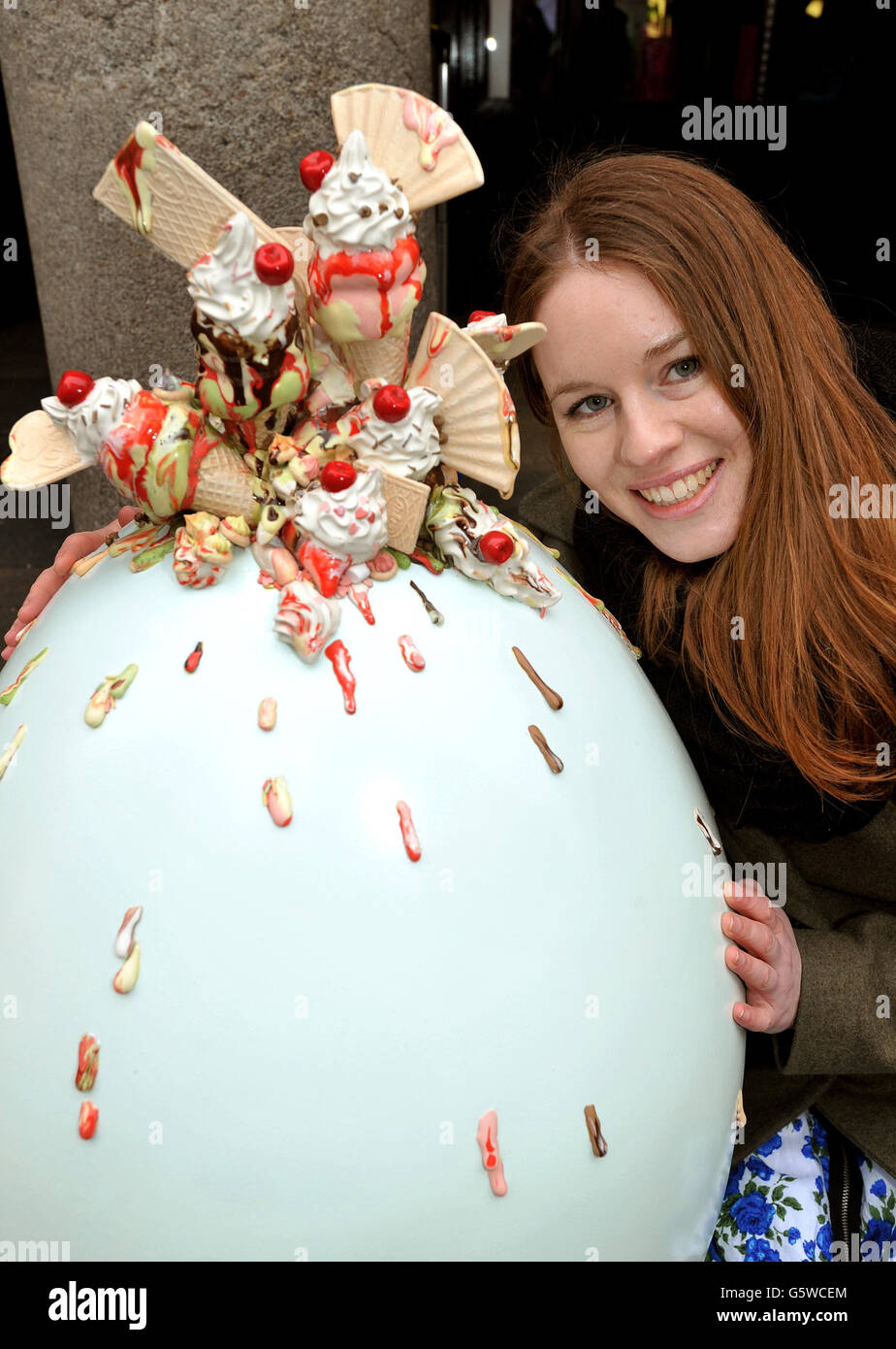 Artist Anna Barlow with her hand-painted and crafted giant Easter Egg, which is one of 100 that will be hidden in cities throughout the country from today until the 1st April, as part of the Lindt Big Egg hunt in support of the Action for Children Charity, in Covent Garden in central London. Stock Photo