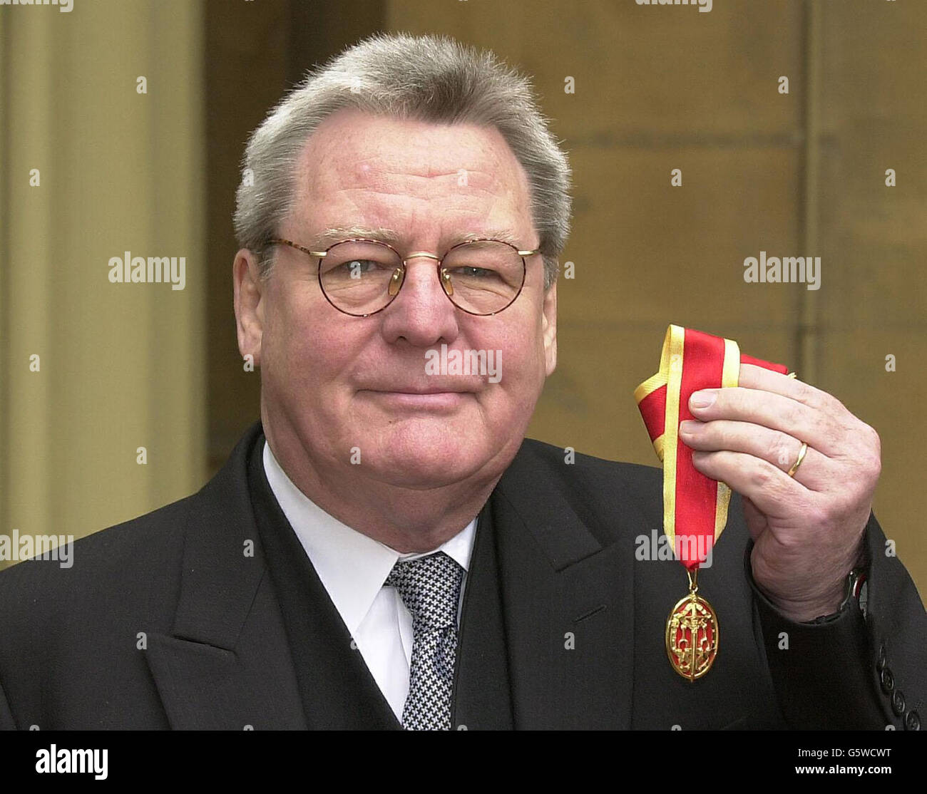 Film director, Sir Alan Parker after receving his Knigthood, at a Investiture ceremony in Buckingham Palace, London. Stock Photo