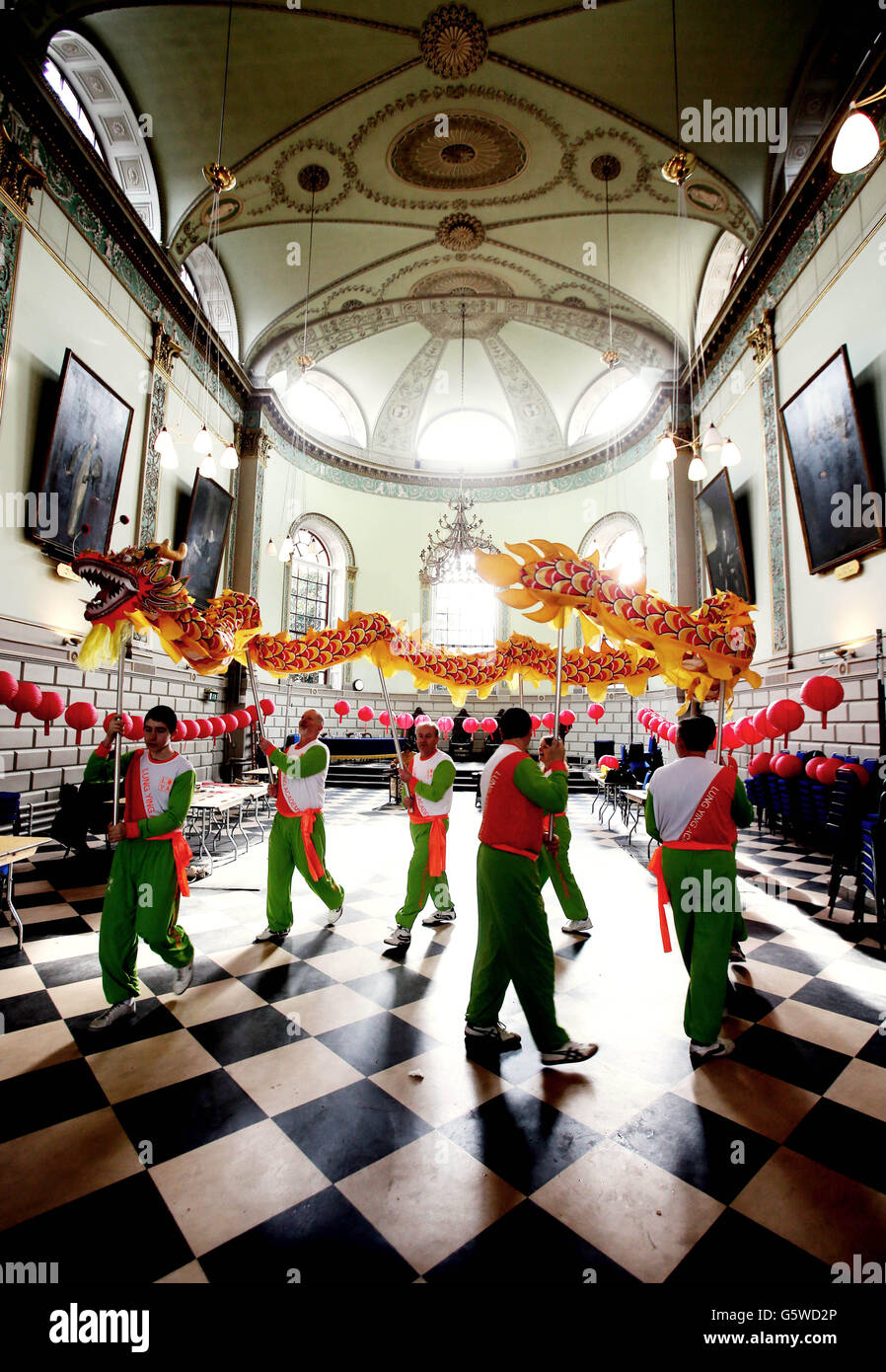Yung Ling dance troupe practice their Chinese new year dragon dance in the exam hall before entertaining students at Trinity College in Dublin. Stock Photo