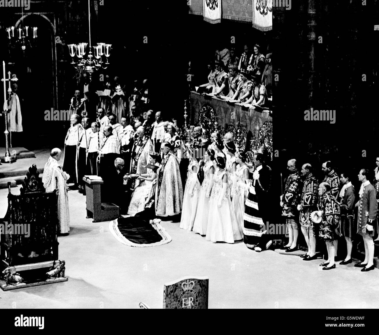 The Moderator of the General Assembly of the Church of Scotland presenting the Holy Bible to the Queen at the Coronation ceremony at the Abbey. Stock Photo