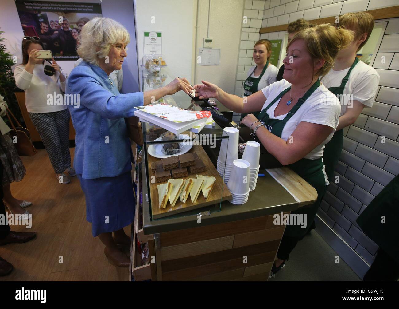 The Duchess of Cornwall, known as the Duchess of Rothesay while in Scotland, speaks to Bonnie Burton (right) as she donates money, during a visit to Social Bite, a cafe in Edinburgh which feeds, trains and employs members of the homeless community. Stock Photo