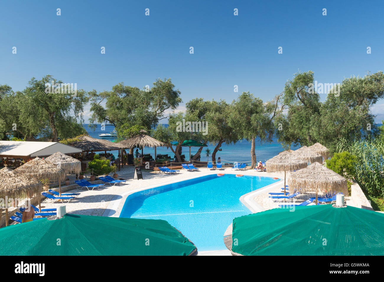 Paxos - people relaxing at the free swimming pool at Bastas Taverna Manadendri Monodendri beach, Greece, Europe and paddle board Stock Photo