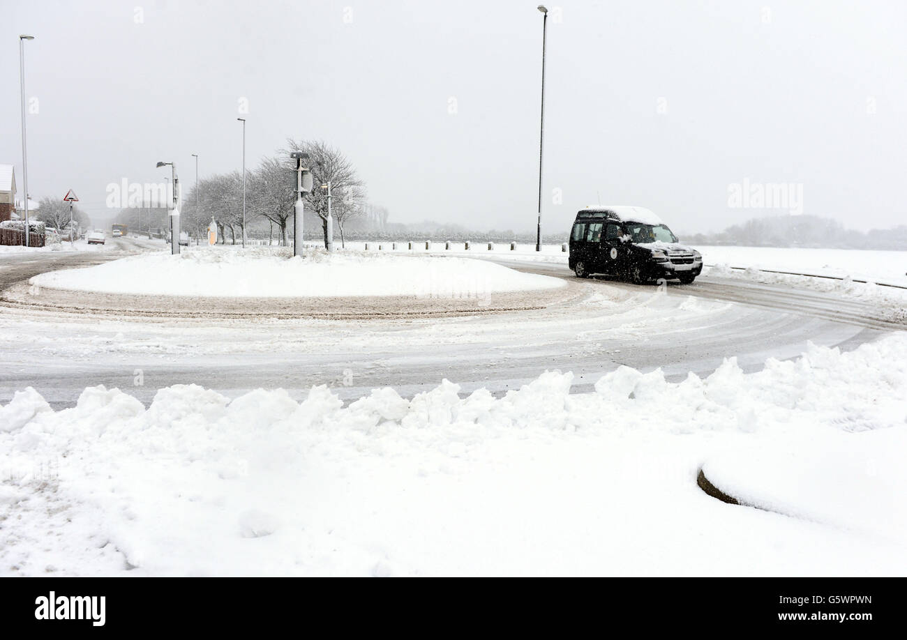 A car struggles in the cold conditions in Wallsend near Newcastle as snow and sleet hit parts of north England today as freezing winds sweep across Britain. Stock Photo