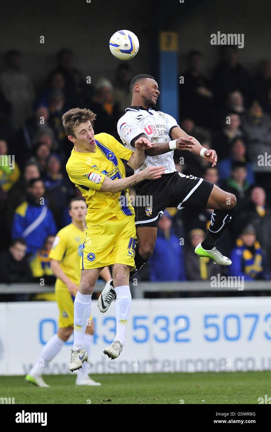 Soccer - npower Football League Two - Torquay United v Port Vale - Plainmoor. Torquay United's Angus MacDonald and Port Vale's Jennison Myrie-Williams in action during the npower League Two match at Plainmoor, Torquay. Stock Photo