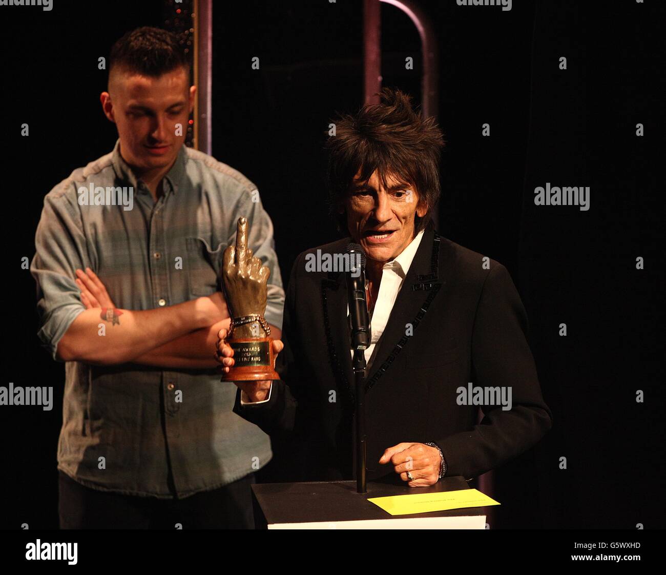 Ronnie Wood collecting the award for Best Live Band on stage during the 2013 NME Awards, at the Troxy, London. Stock Photo