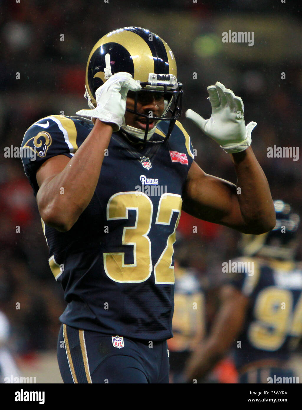 Former St. Louis Rams Isaac Bruce holds the Super Bowl trophy during  ceremonies celebrating the teams Super Bowl victory in the 1999-2000  season, at the Edward Jones Dome during half time of