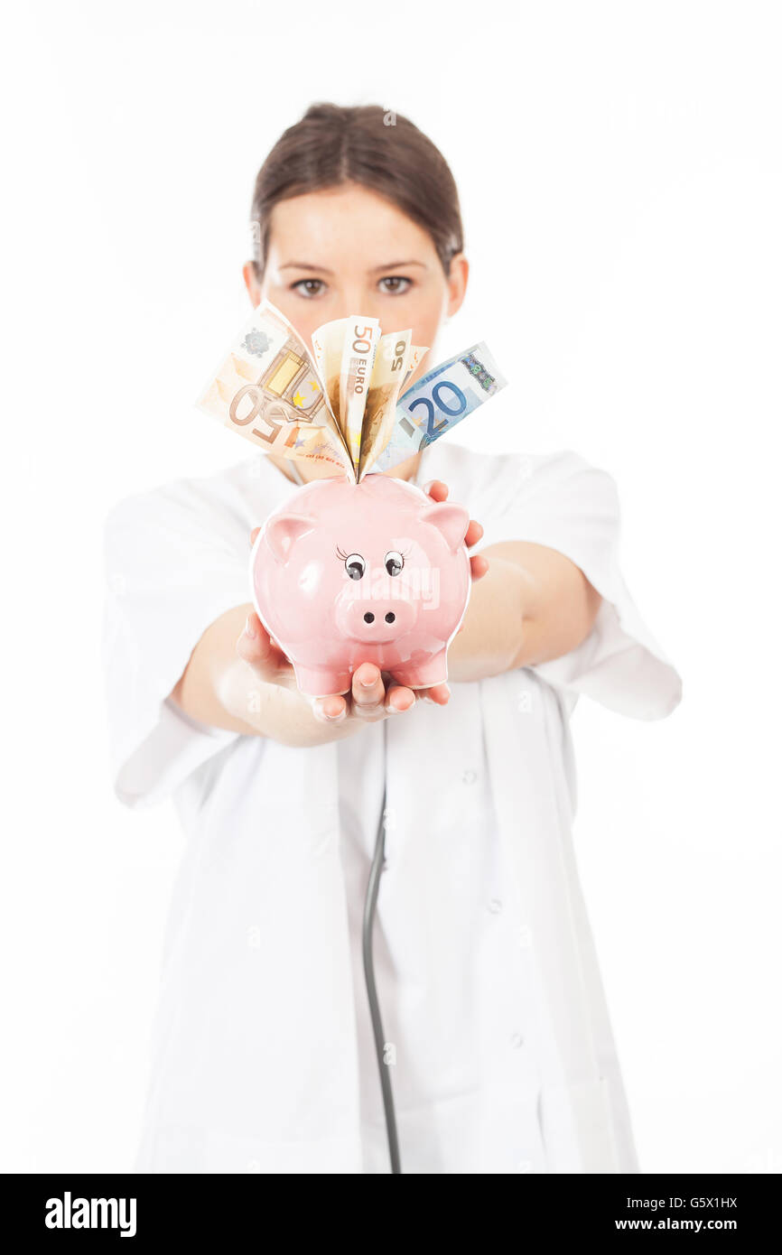 A woman shows a piggy bank full of European banknotes Stock Photo - Alamy