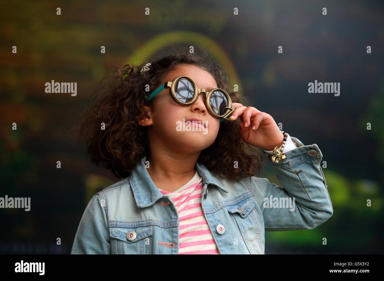 Amelia Brown, aged 5, from London wears a pair of Real Ds glasses as she interacts with the touch screens at the interactive Oz Experience, created by RealD, Vue Cinemas and Walt Disney Pictures at Vue Westfield London, to mark the upcoming 3D release of Oz the Great and Powerful. Stock Photo