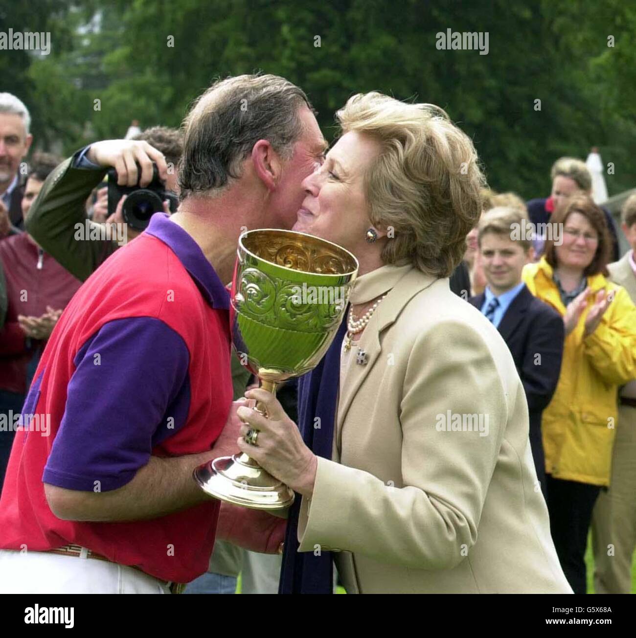The Prince of Wales kisses Queen Anne Marie of Greece after his Highgrove team had beaten Cirencester Park in The King Constantine Cup 2002 in aid of the Hellenic College Trust at Cirencester Park Polo Club. Stock Photo