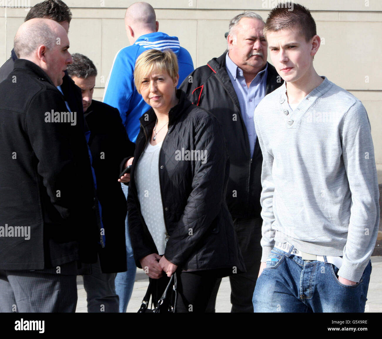 Ann Frazer, wife of Willie Frazer and their son Philip (right) outside Belfast's Magistrates Court as the prominent loyalist campaigner involved in Union flag protests in Northern Ireland has been refused bail after being accused of encouraging or assisting offences. Mr Frazer, 52, faces six charges linked to the ongoing demonstrations. Stock Photo