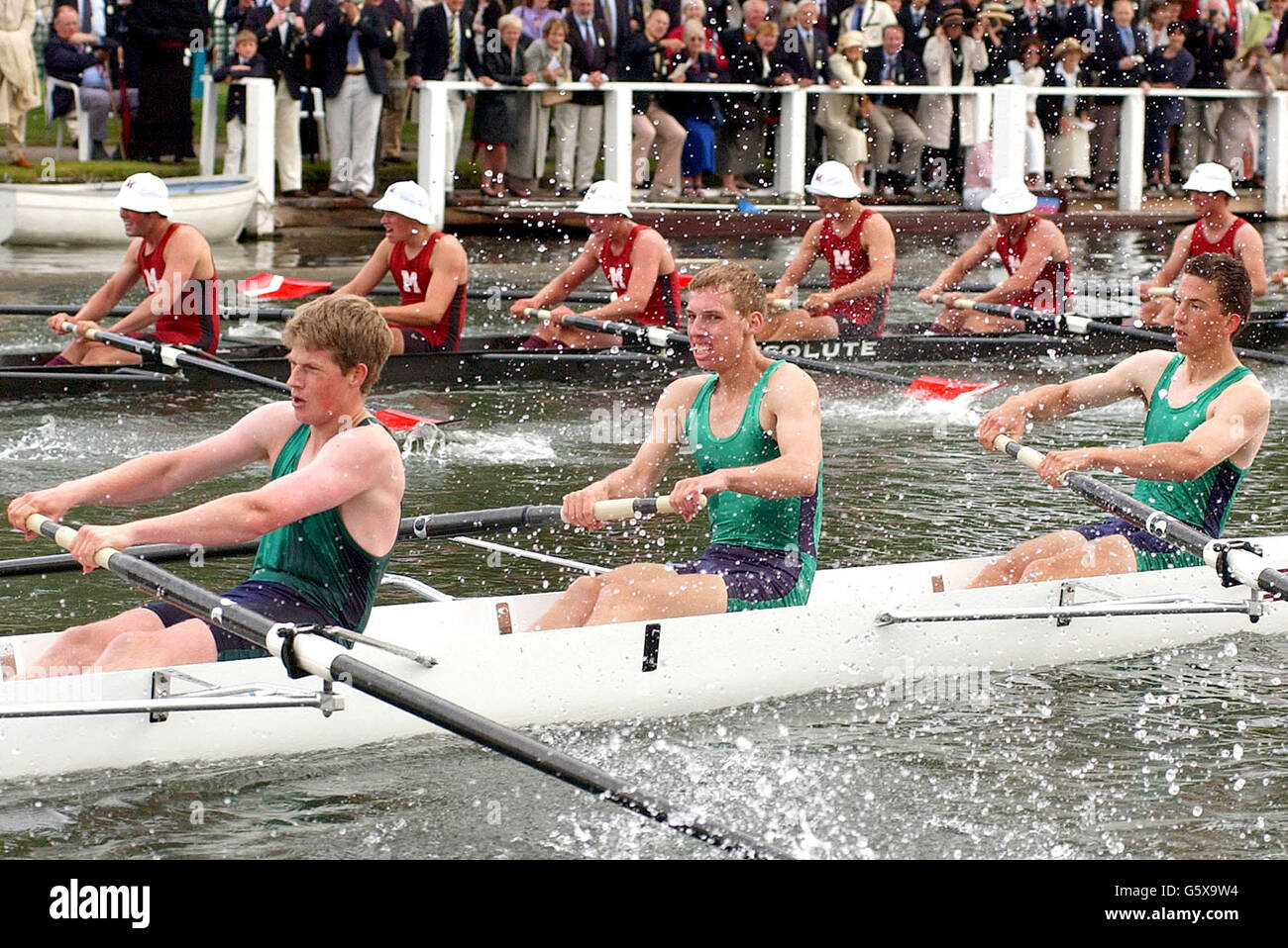 Royal Grammer School Worcester (green foreground) in action against Middlesex School USA in the Princess Elizabeth Challenge Cup at the 153rd Henley Royal Regatta. Fans braved chilly weather and showers to quaff champagne by the river bank and watch the rowers glide by. Stock Photo