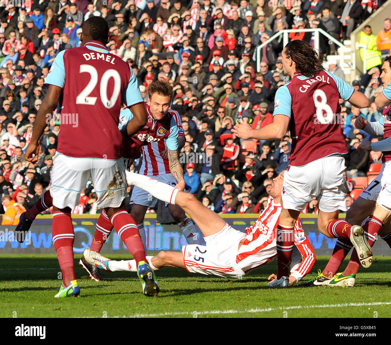 Stoke City's Peter Crouch tries an overhead kick but floors West Ham United's Matthew Taylor during the Barclays Premier League match at the Britannia Stadium, Stoke. Stock Photo